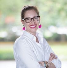 Lauren Sinclair headshot white blouse pink earrings outdoor background